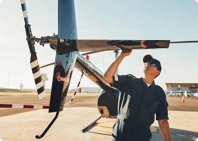 Mechanic inspecting a helicopter rotor